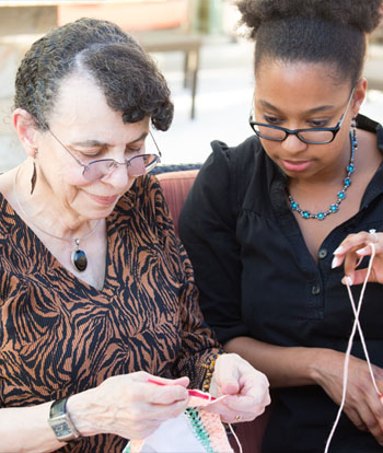 Senior resident being helped by younger woman